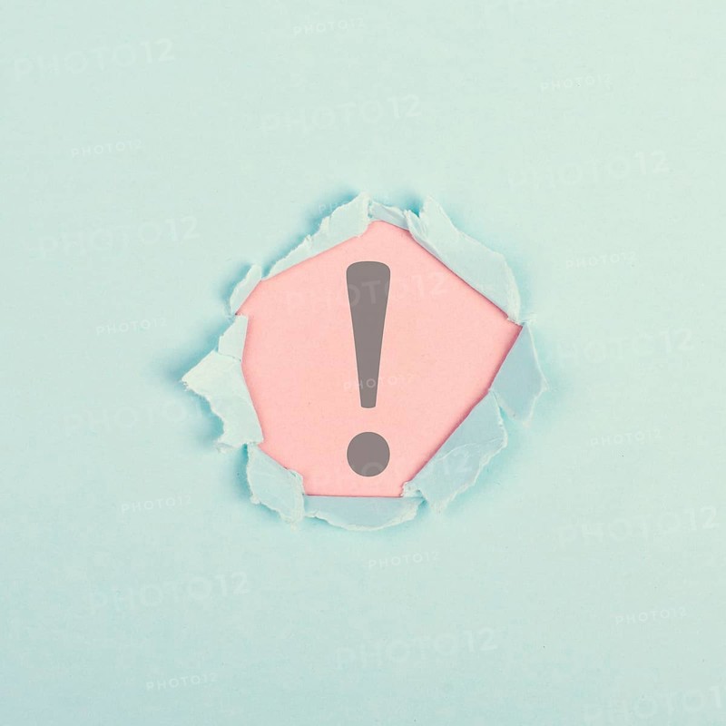 Exclamation mark surrounded by torn paper, alert sign, information and warning concept