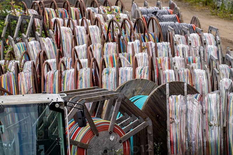Cable drums with conduits for fibre optic cables, in a storage yard, North Rhine-Westphalia, Germany, Europe