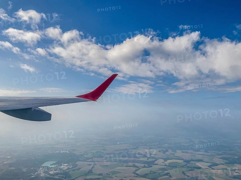 View from aircraft window of upwardly curved extended wing wing tip for better flow behaviour on wings of civil aircraft jet passenger aircraft cargo aircraft, Winglet, Sharklet, Raked Wingtip, aviation, international