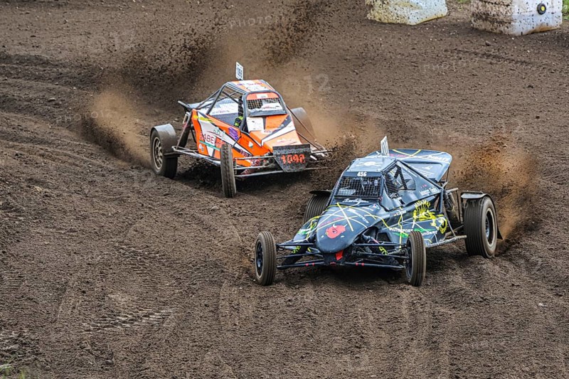 Grambek, Germany, September 10, 2022: Car racing Autocross ADAC NAX-Club Moelln, two special buggies on the race track on dirt and soil, copy space, selected focus, motion blur, Europe