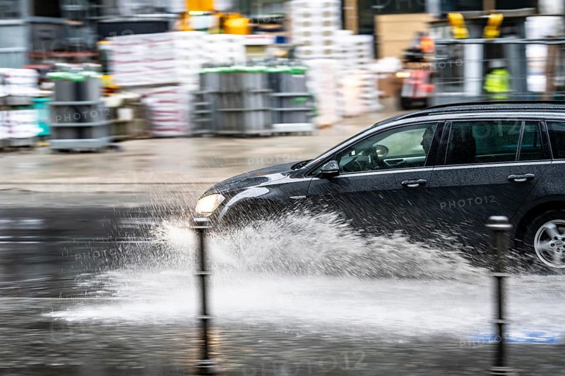 Winter, rainy weather, freezing rain, large puddle, puddle of water, in the city centre, Grosse Gallusstrasse, vehicles driving through, spraying water fountains, Frankfurt am Main, Hesse, Germany, Europe