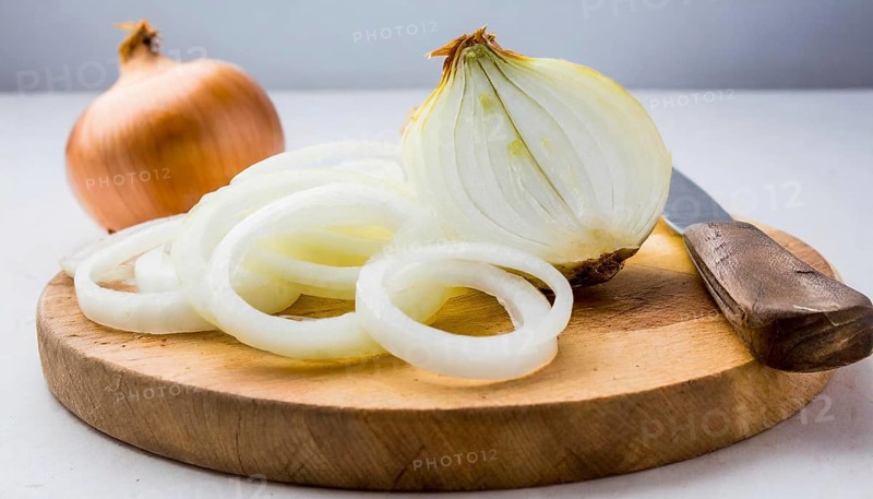Vegetables, onion, Allium cepa, freshly cut onion rings on a wooden board, Studio