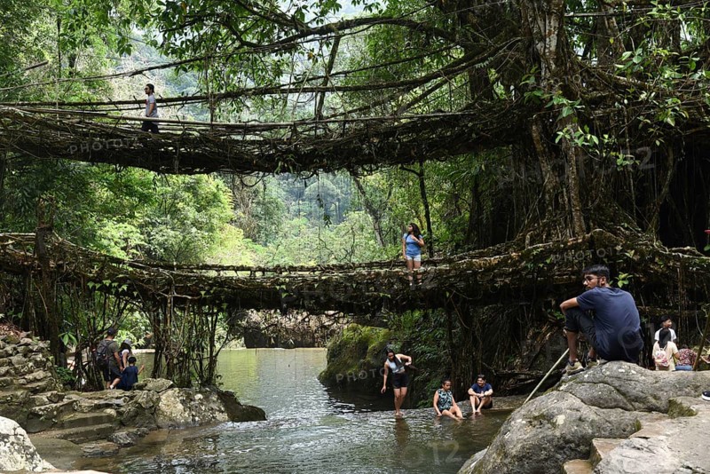 Tourists at the Bouble decker living root bridge amid COVID-19 coronavirus pandemic, in Nongriat village in Northeastern India state Meghalaya, on 19 April 2021. The living root bridges, created by the members of the Khasi tribe who have grown them from rubber trees, are native to the region. The double-decker root bridge, is the most famous one near Cherapunji