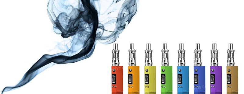 Eight multicolored electronic cigarettes and smoke, isolated on white background