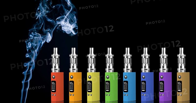 Eight multicolored electronic cigarettes and smoke, isolated on black background