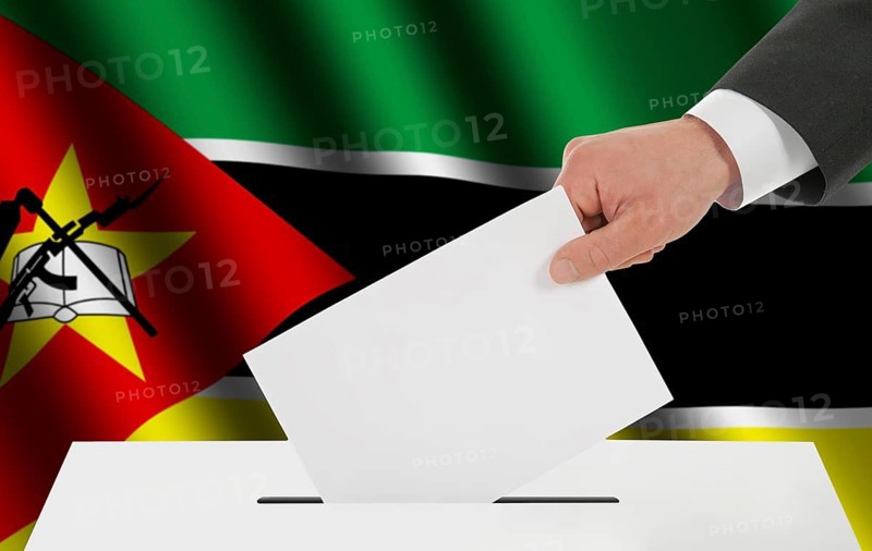 The Mozambique flag and the hand with the bulletin about the ballot box