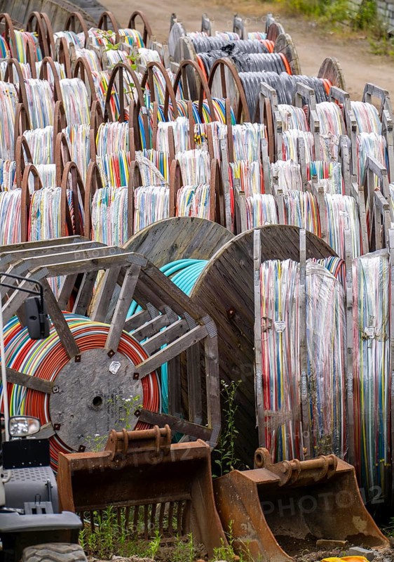 Cable drums with conduits for fibre optic cables, in a storage yard, North Rhine-Westphalia, Germany, Europe