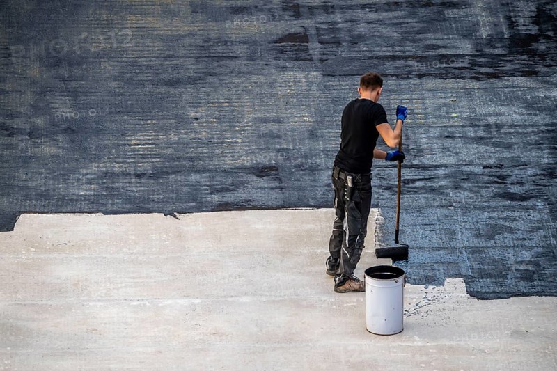 Construction site, application of a bitumen coating to a concrete ceiling, preparation for waterproofing, with bitumen membranes applied thermally, Duisburg, Germany, Europe
