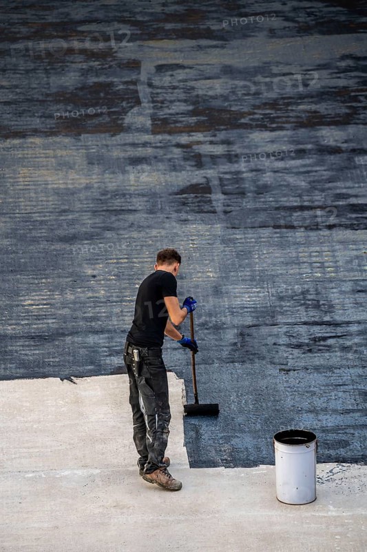 Construction site, application of a bitumen coating to a concrete ceiling, preparation for waterproofing, with bitumen membranes applied thermally, Duisburg, Germany, Europe