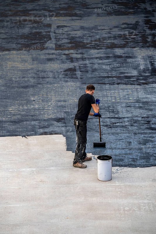 Construction site, application of a bitumen coating to a concrete ceiling, preparation for waterproofing, with bitumen membranes applied thermally, Duisburg, Germany, Europe