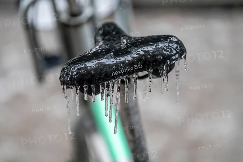 Freezing rain, icy saddle of a rental bike, after freezing rain, in the city centre of Frankfurt, Hesse, Germany, Europe