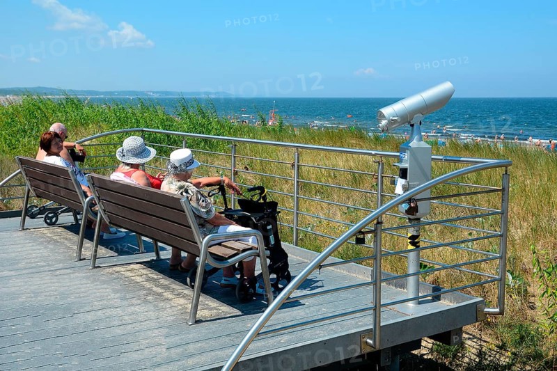 Elderly women sit on viewpoint by the beach to the Baltic Sea in Swinoujscie, Swinemünde, West Pomerania, Poland, Europe