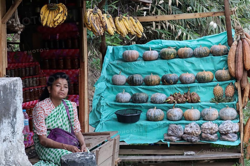A khasi woman vendor selling home grown vegetables in her roadside stall, in Nongpoh, Meghalaya, India on 20 April 2021