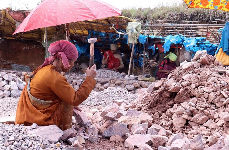 Khasi women breaking stones into different sizes by hammer, in a village in Meghalaya, India on 20 April 2021. Women stone breakers eke out a living by working at the make-shift quarries, and the men assisting them by bringing down the big stones from the hillock
