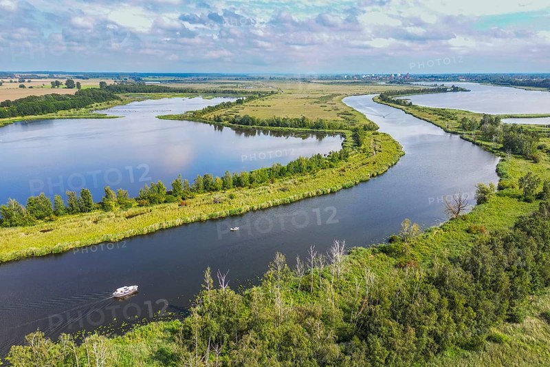 Aerial view, drone photo: Boats on the river Peene with wetlands and lakes, in the background the town of Anklam, Flusslandschaft Peenetal nature park Park, Anklam, Mecklenburg-Western Pomerania, Germany, Europe