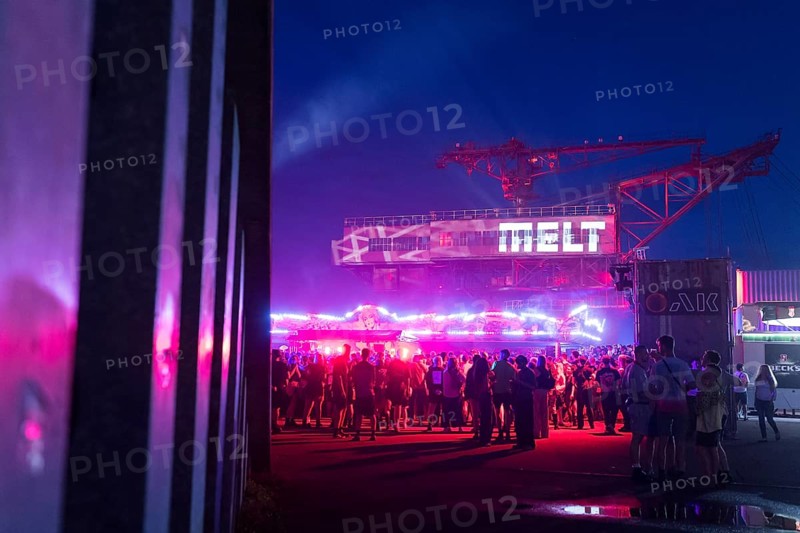 Festival visitors in front of an excavator with logo at the Melt Festival in Ferropolis on 12 July 2024. After a total of 27 years, the festival will take place for the last time in 2024