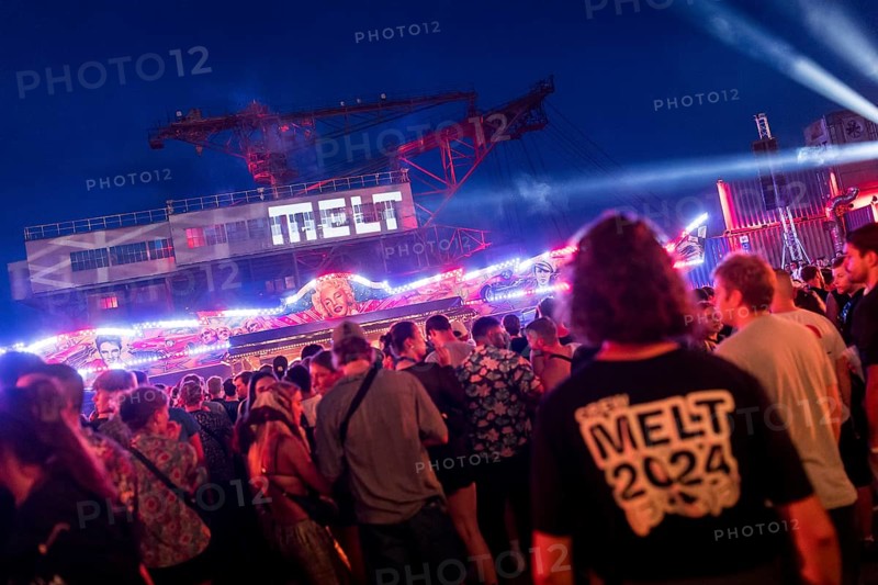 Festival visitors celebrate between bumper cars and excavators at the Melt Festival in Ferropolis on 12 July 2024. After a total of 27 years, the festival will take place for the last time in 2024