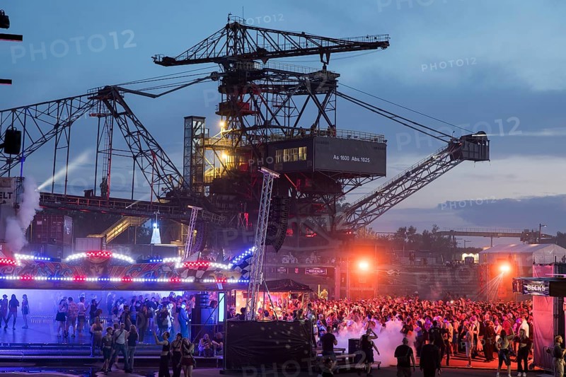 Festival visitors celebrate between excavators at the Melt Festival in Ferropolis on 12 July 2024. After a total of 27 years, the festival will take place for the last time in 2024