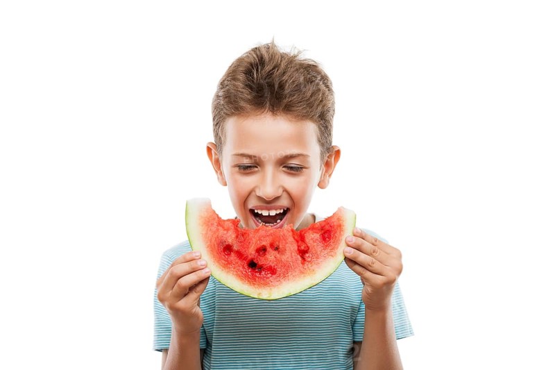Handsome smiling child boy hand holding red ripe watermelon fruit food slice white isolated