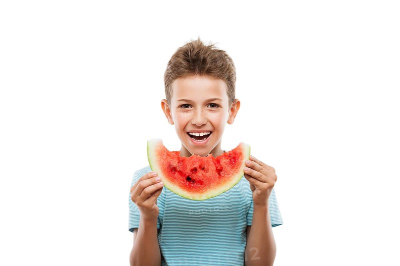 Handsome smiling child boy hand holding red ripe watermelon fruit food slice white isolated