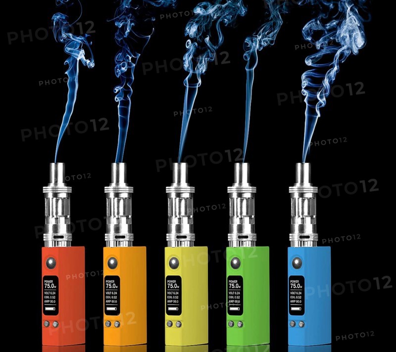 Five multicolored electronic cigarettes and steam, isolated on black background