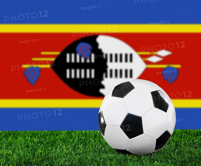 The Swaziland flag and soccer ball on the green grass