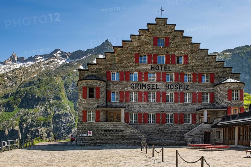 Frontal view of Hotel Grimselhospiz Grimsel Hospiz with stepped gable gable with stepped contour and red shutters on pass road Alpine pass mountain pass pass in Swiss Alps from to Grimselpass, Guttanen, Canton Bern, Switzerland, Europe