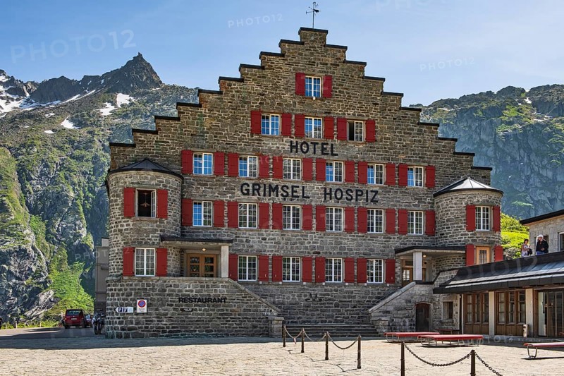 Frontal view of Hotel Grimselhospiz Grimsel Hospiz with stepped gable gable with stepped contour and red shutters on pass road Alpine Pass Pass in Swiss Alps from to Grimselpass, Guttanen, Canton Bern, Switzerland, Europe