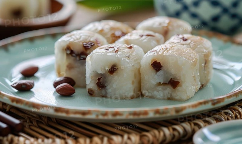 Chinese sweet rice cakes with red bean on a pastel green plate AI generated