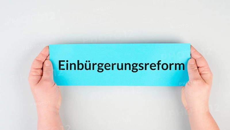 Naturalization reform is standing in german language on the paper, new law in Germany for immigrants and asylum seekers to receive citizenship