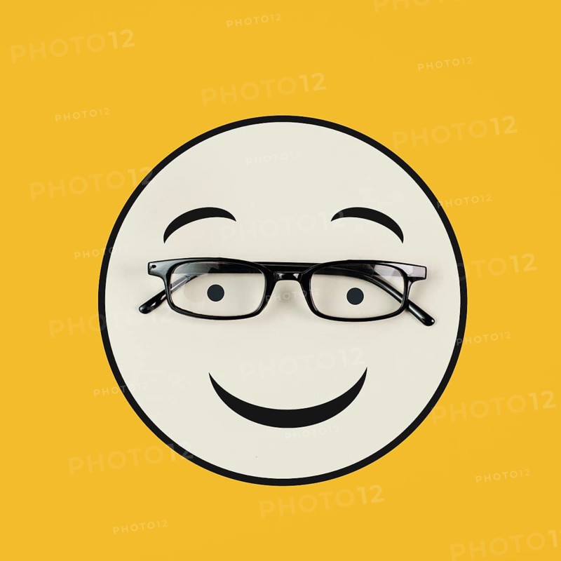 Head with a happy face and eyeglasses, mental health concept, positive mindset, support and evaluation symbol