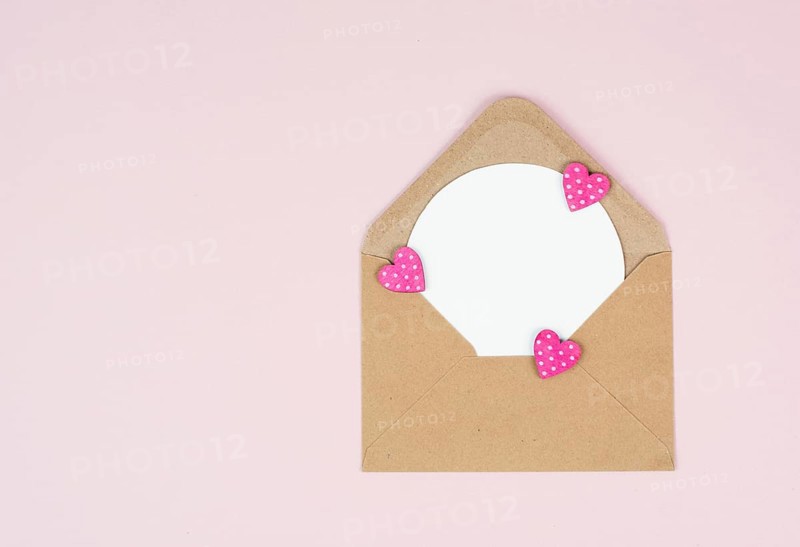Valentine day greeting card, envelope with hearts on pastel background, love symbol, flat lay