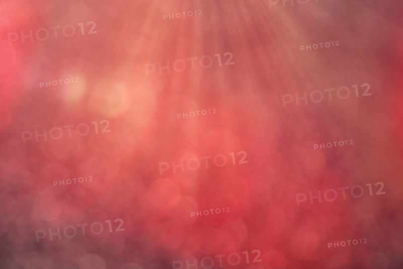 Red bokeh background with defocused round lights and sunbeams, flare overlay