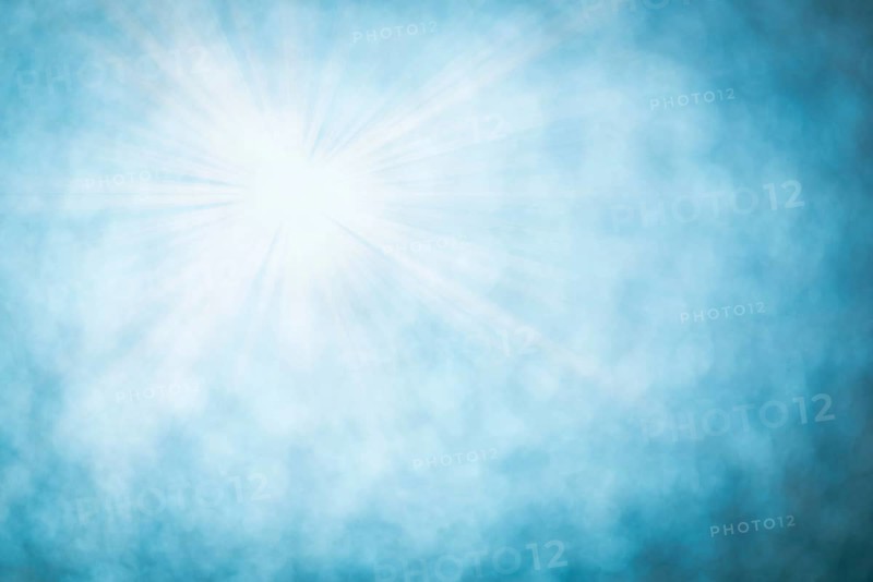 Blue bokeh background with defocused round lights and sunbeams, flare overlay