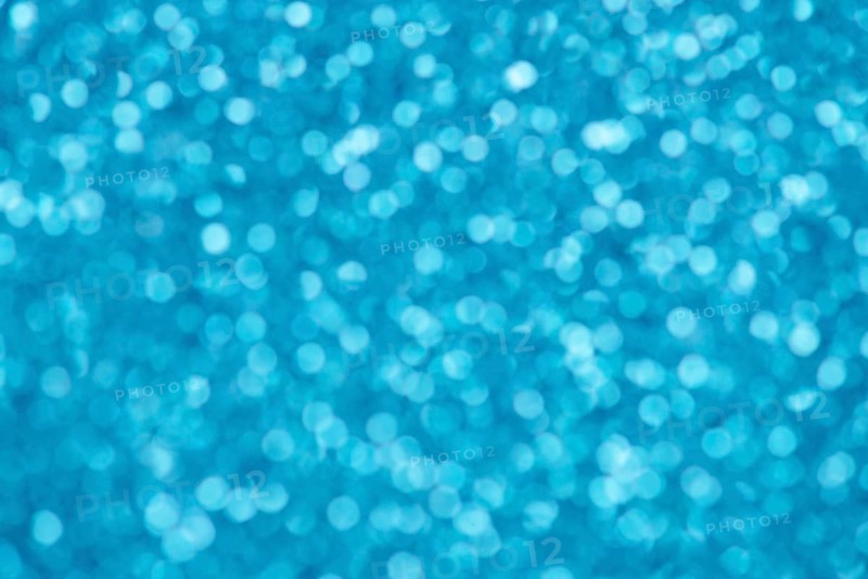 Blue bokeh background for christmas, defocused round lights and sunbeams, flare overlay