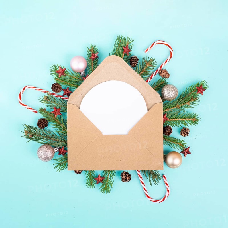 Christmas holiday background, enveloep with fir branches, baubles, candy cane and cones, winter season greeting card