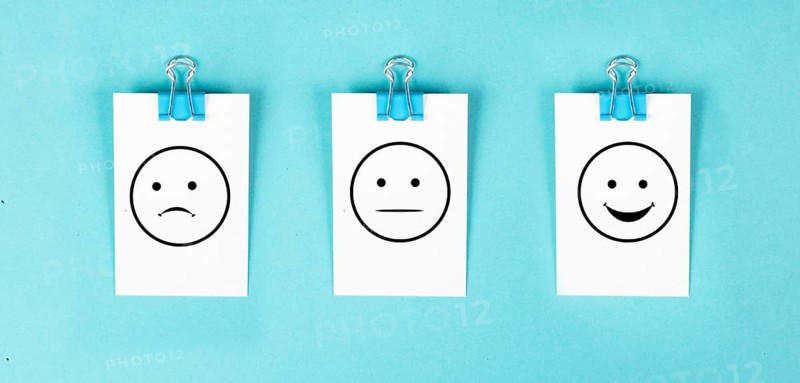Head with a sad and a happy face, mental health concept, positive and negative mindset, depression, support and evaluation symbol, emotion