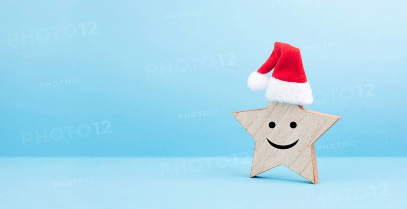 Star with a happy smiling face expression, red christmas hat, winter greeting card and banner, copy space