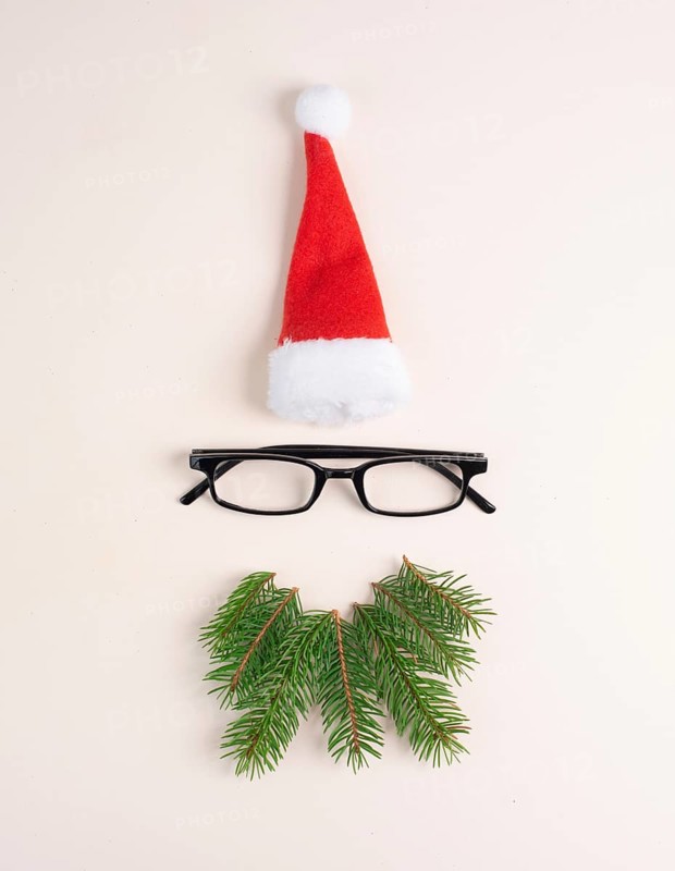 Christmas season, Santa Claus face with a red hat, eyeglasses, beard made from fir twigs, wintertime, holiday greeting card