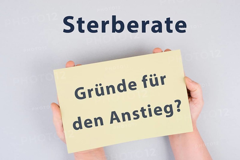 The german words for mortality rate, reasons for the increase are standing on the paper, covid-19 pandemic deaths, vaccine damage