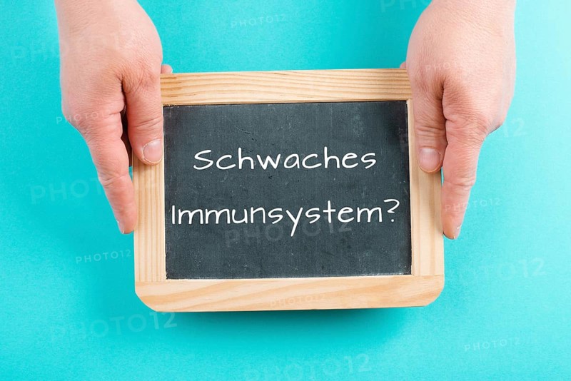 Weak immune system is standing in german language on a chalkboard, healthy eating and lifestyle concept, natural protection from disease