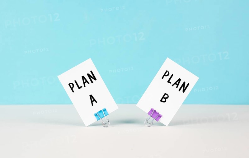 Plan A and B standing on paper, brainstorming for possibilities, making a decision