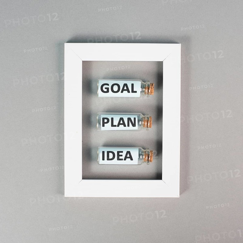 Three glass bottles with the words idea, plan and goal in a frame, education, marketing and business concept, brainstorming for new targets