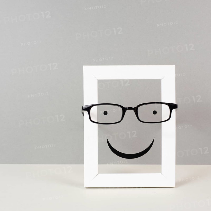 Frame with a happy face with eyeglasses, mental health concept, positive mindset and emotion, support and evaluation symbol