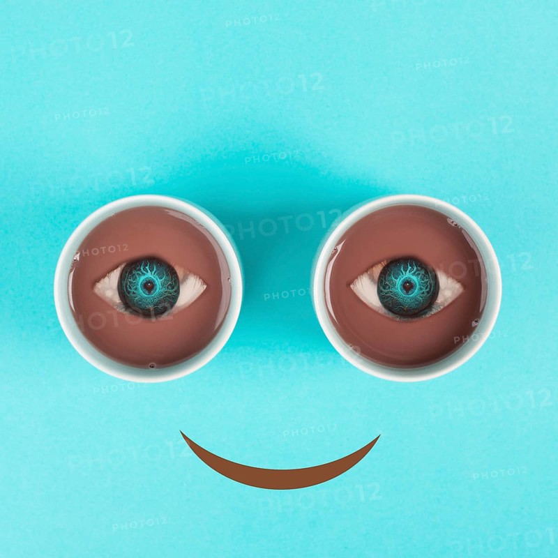 Cup of coffee building the eyes of the funny face, mouth is smiling, wake up in the morning, hot drink with caffeine