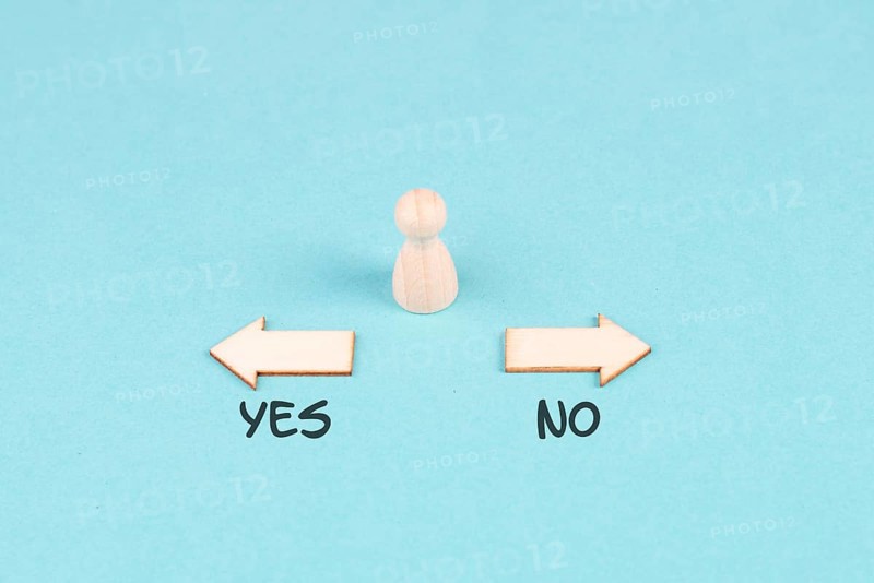 Men stands in front of two arrow with the words yes and no, making a decision, asking questions, looking for an answer