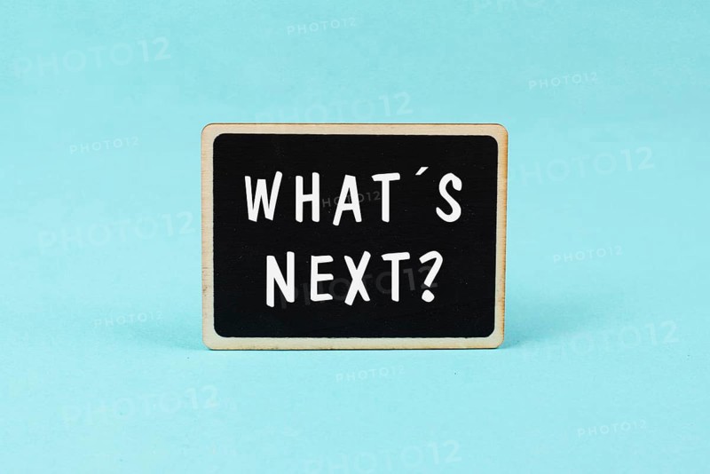 The phrase whatÂ´s next is standing on a chalkboard, having new goals and strategies, making plans for future