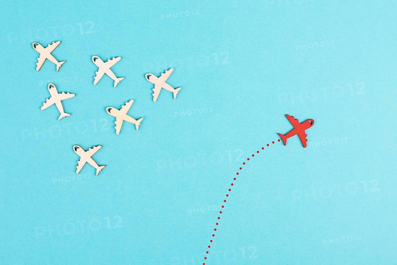 Airplanes following the group, red plane thinks different and takes the opposite direction, leadership, courage and winner concept