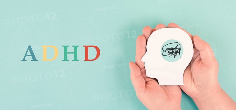 Hands holding a silhouette of a human head, attention deficit hyperactivity disorder, ADHD symptom, mental health