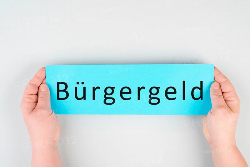 The german word for citizen money is standing on a paper, new financial help system for unemployment in Germany, social issue